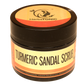 In this image, a small container of turmeric sandal scrub, a natural beauty product by herbstonic, a herbal skincare brand.