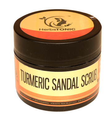 In this image, a small container of turmeric sandal scrub, a natural beauty product by herbstonic, a herbal skincare brand.